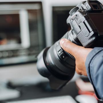 Hand holding a professional camera