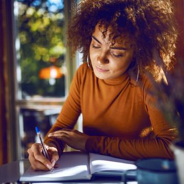 Woman writing in a notebook