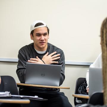 Student conversing in sign language in a classroom