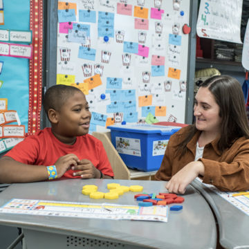 Saint Joseph's student working with a young child in an elementary school classroom
