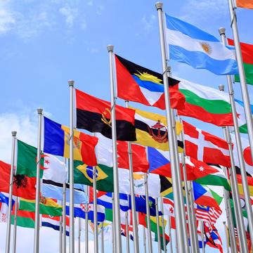 Group of flags from around the world blowing in the wind