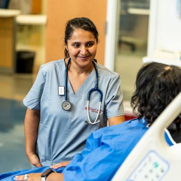 Student in nursing program speaking with a patient