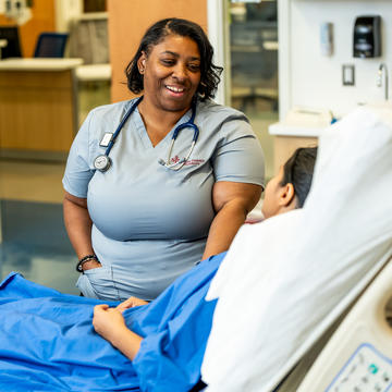 Nursing student speaking with a patient