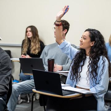 Student raising hand in classroom