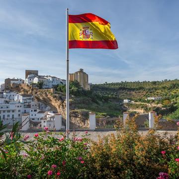 Spanish flag hanging with a Spanish city in the background