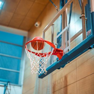 Basketball going into a basketball hoop