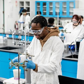 Student working with chemistry equipment in a lab