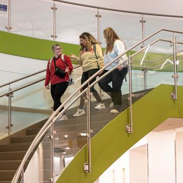 Three students walking down steps on Saint Joseph's Lancaster campus
