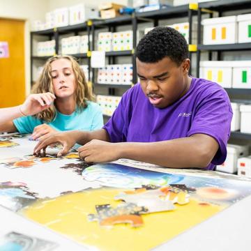 Saint Joseph's student teaching a young student in a classroom