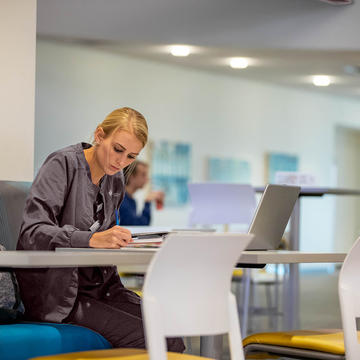 Female nursing student studying at a table
