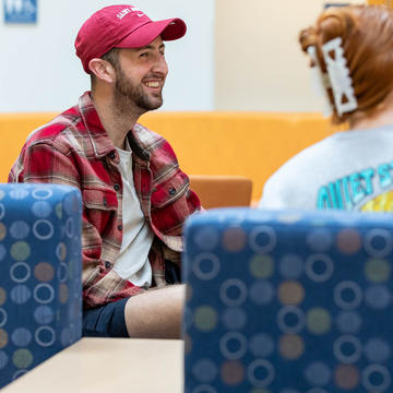 Male student with friends in hallway lobby