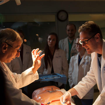 Students observing a manikin demonstration inside PCOM facilities