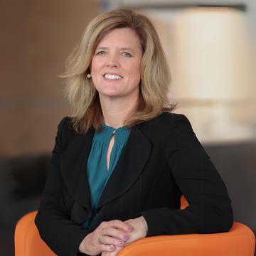 Headshot of Jean McGivney-Burelle, PhD, seated in an orange chair