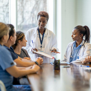 Clinical leader speaking to group of nurses 