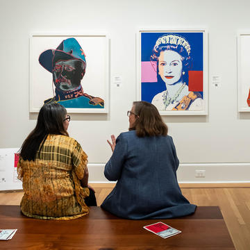 Teacher sitting next to student in Saint Joseph's Maguire Museum