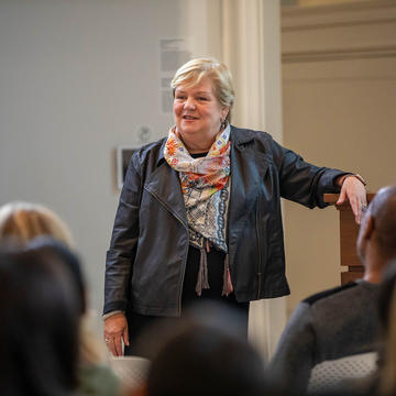 Female superintendent standing in front of students in classroom