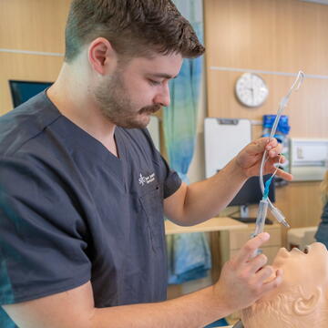 Saint Joseph's University in Lancaster student working on a model in a clinical lab setting