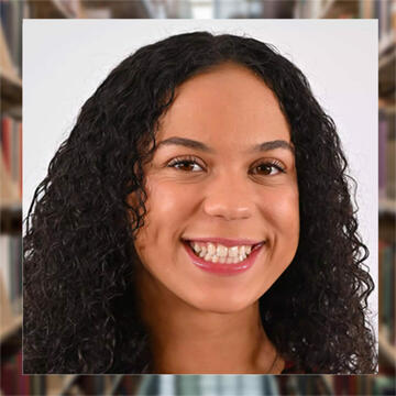 female with curly hair smiling