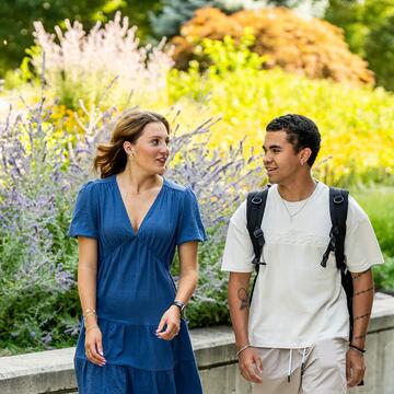 Male and female students walking outside on campus