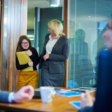 Female employer with female neurodiverse employee in office