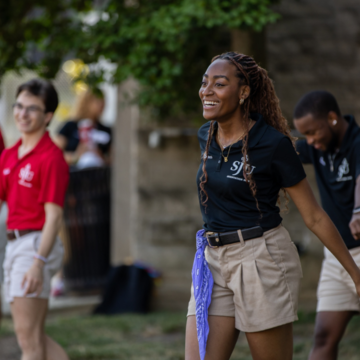 Orientation leader smiling welcoming students