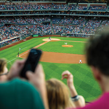 Fans sitting in the stands watching a baseball game