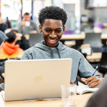 student sitting in front of laptop