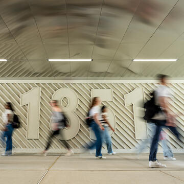 Students walking in Post Cross tunnel