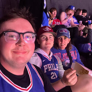 Three dudes watching a basketball game