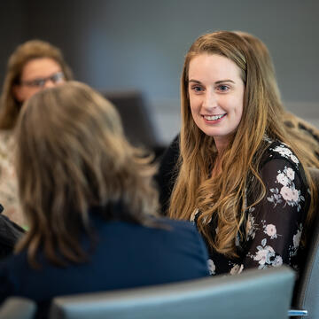 Two seated women talking