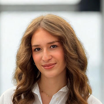 A woman with long hair looking at the camera