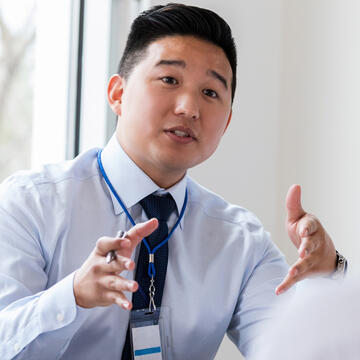 Man talking to colleagues at table