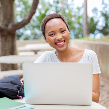 continuing ed student sitting at laptop