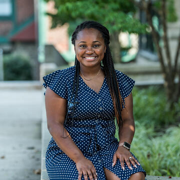 smiling female student sitting outside