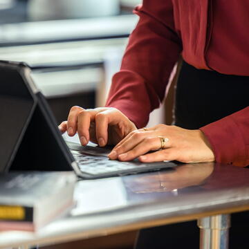 fingers typing on a laptop 
