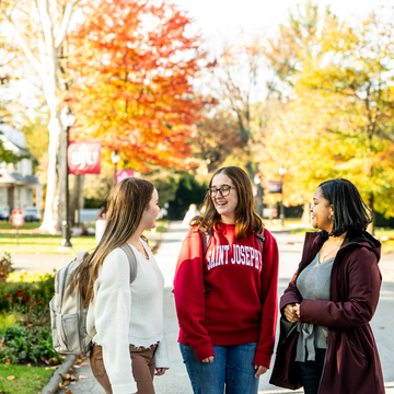 Three students standing outside on Lapsley Lane talking