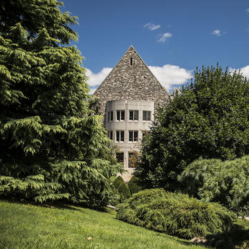Mandeville Hall being seen through the trees.