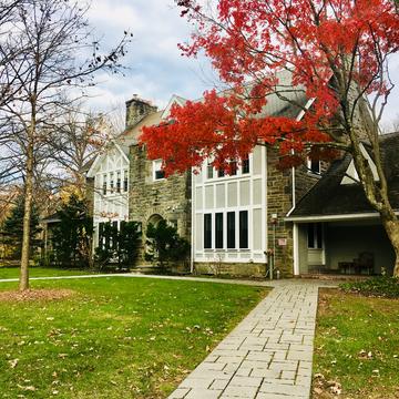 The path leading to Hogan Hall with fall foliage