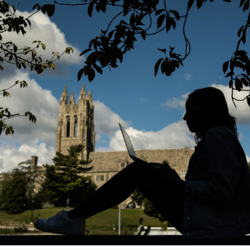Student studying on laptop outside Barbelin