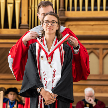 Elaine Estes, Class of 2019, receiving a medal from Mark C. Reed, Ed.D., University Prep