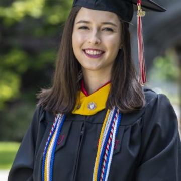 Elise smiles in her cap and gown