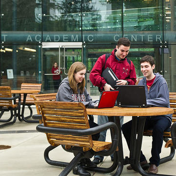 three students talking on saint joseph's university campus