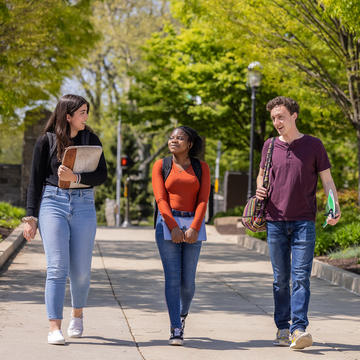 Undergraduate students walking towards Saint Joseph's Library