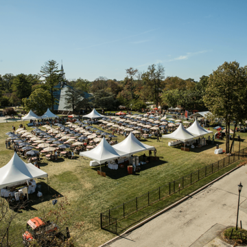 White tents covering tables on Curran Field during HawkFest 2017