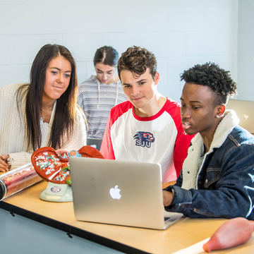 3 saint joseph's university health studies majors looking at a laptop