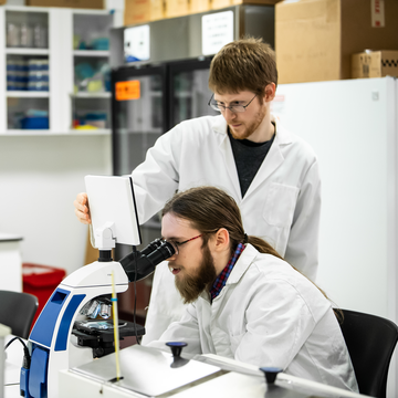 two students conducting research in a lab
