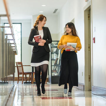 two female saint joseph's university walking in the hallway