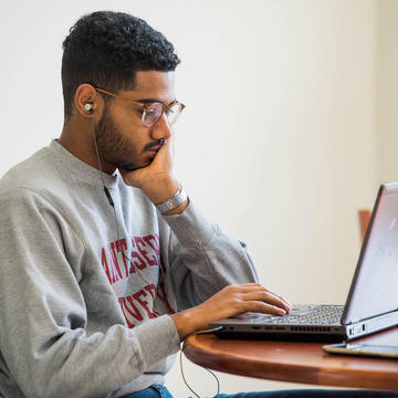 saint joseph's university student looking at a laptop