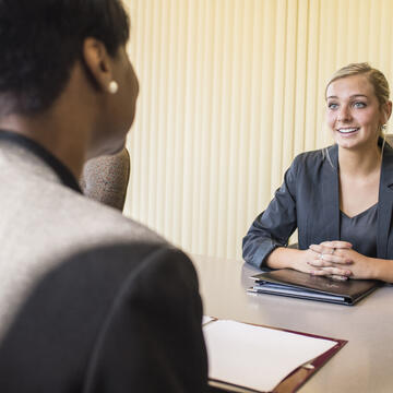 A student is interviewed by an employer 
