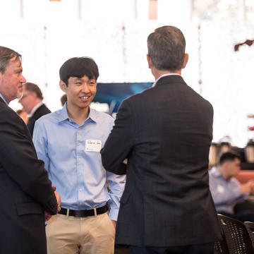 A group of alumni chat in the foley center